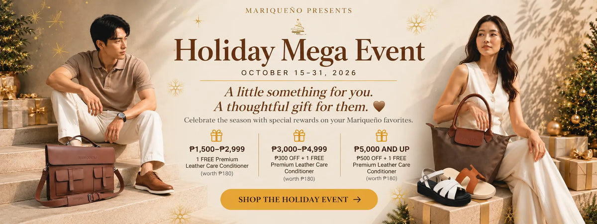 Promotional banner for a 'Holiday Mega Event' by Mariqueno, featuring a man in a beige shirt sitting next to a brown leather suitcase and a woman in a white dress holding a brown handbag next to a gift box. The background is a warm beige with gold leaf patterns and text detailing event dates and pricing in PHS.