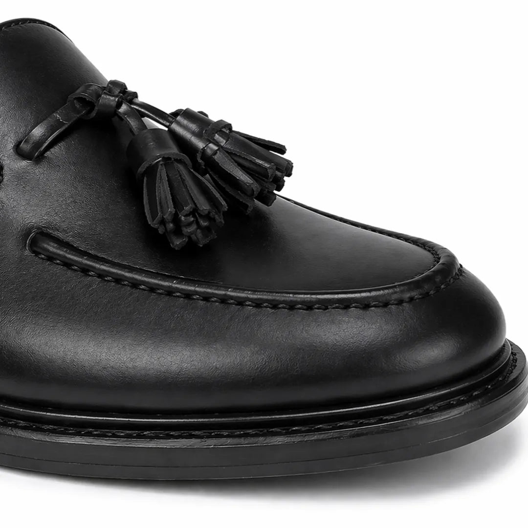 Black leather loafer with tassel on a white background
#color_black