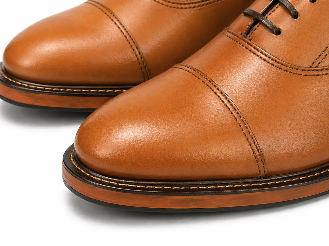 Close-up of brown leather shoes on a white background
#color_tan