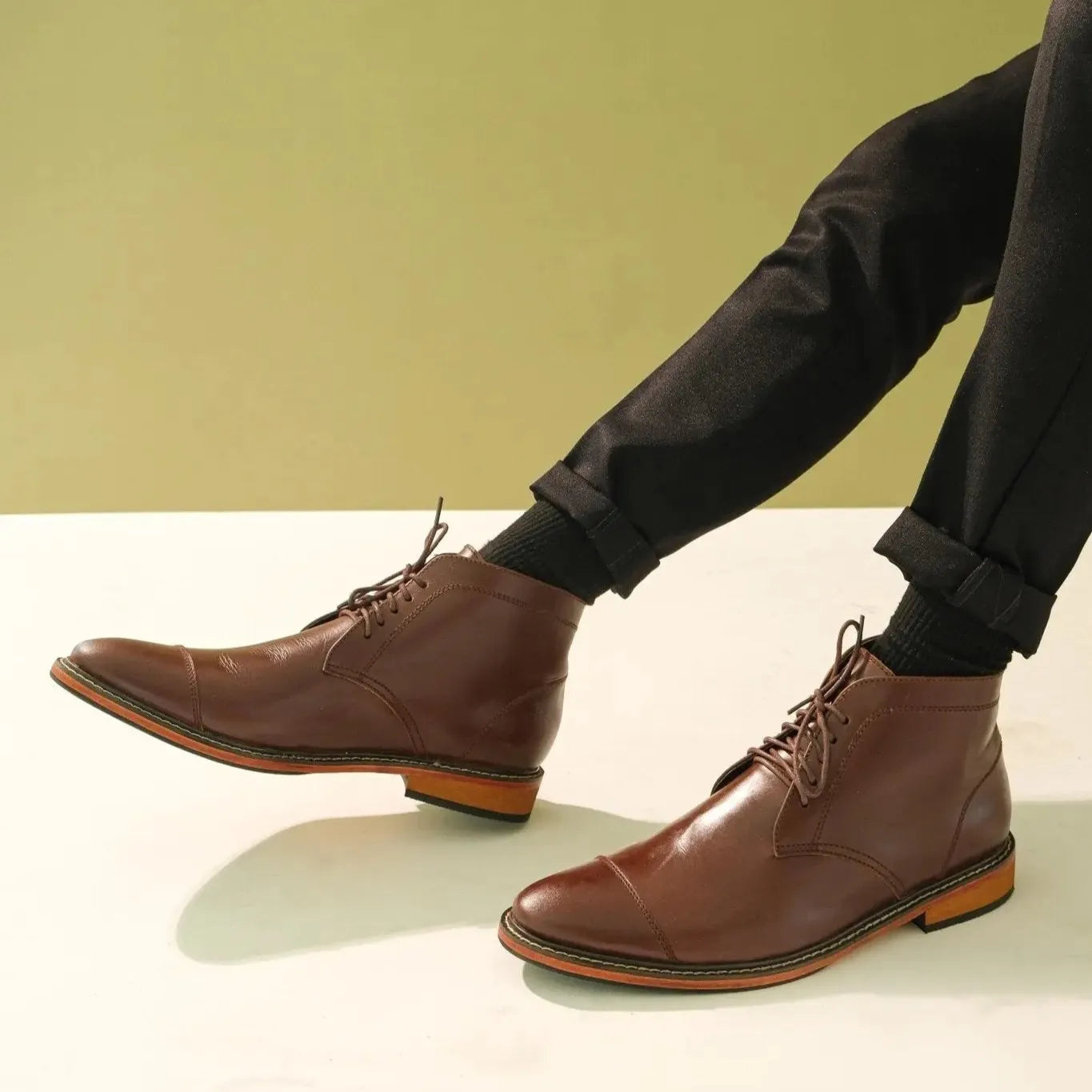 A pair of walnut brown Chukka Boots worn by model
#color_walnut