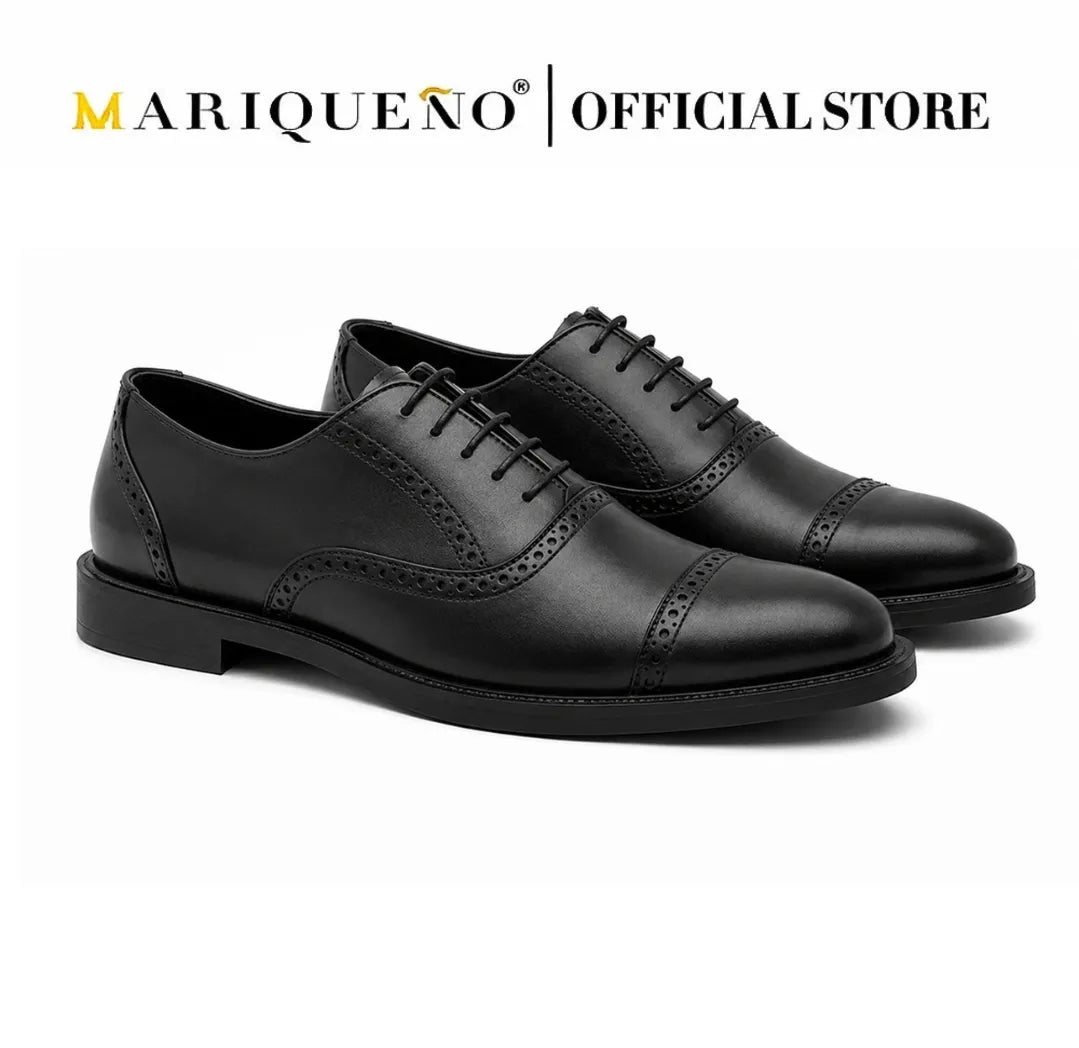 Black oxford with holes shoes with 'Mariqueno' branding on a white background
#color_black