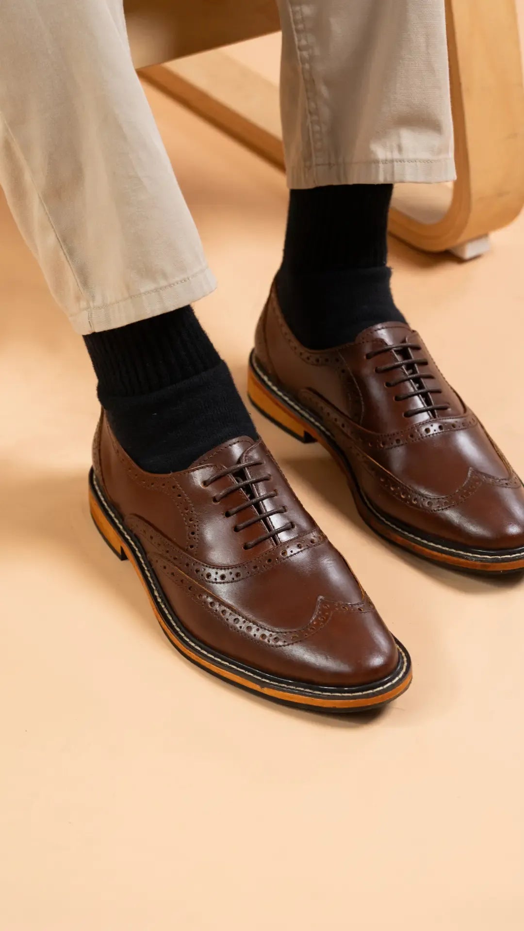 Walnut brown dress shoes worn with black socks on a beige background
#color_walnut
