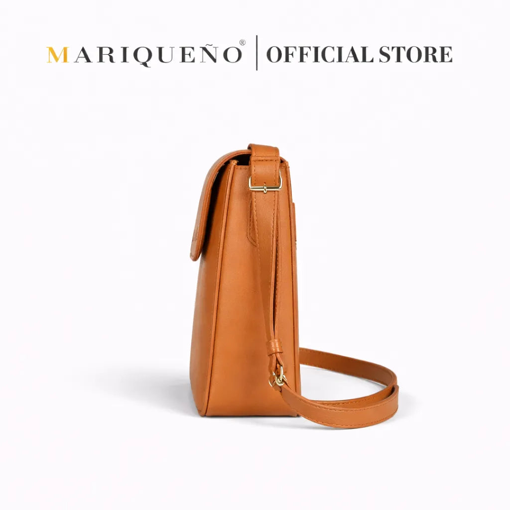 Brown leather crassbody bag with visible brand name on a white background
#color_tan