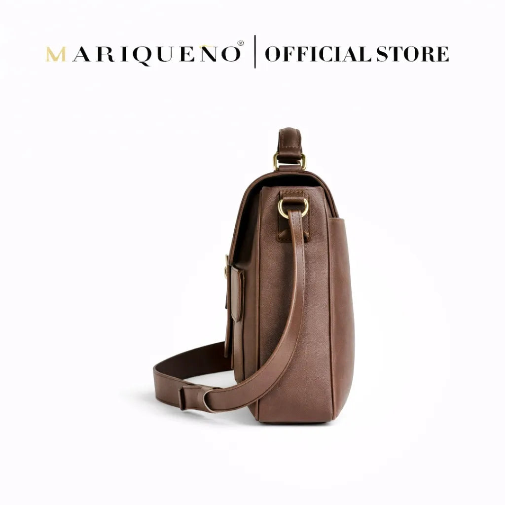 Brown leather sling bag with 'Mariqueno' branding on a white background
#color_walnut