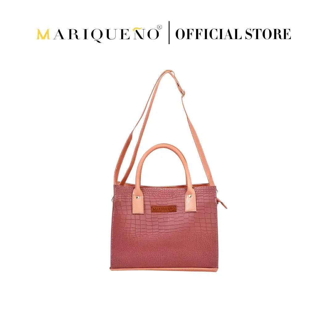 Pink handbag with tan accents on a white background, featuring the Mariqueño brand.
#color_old rose