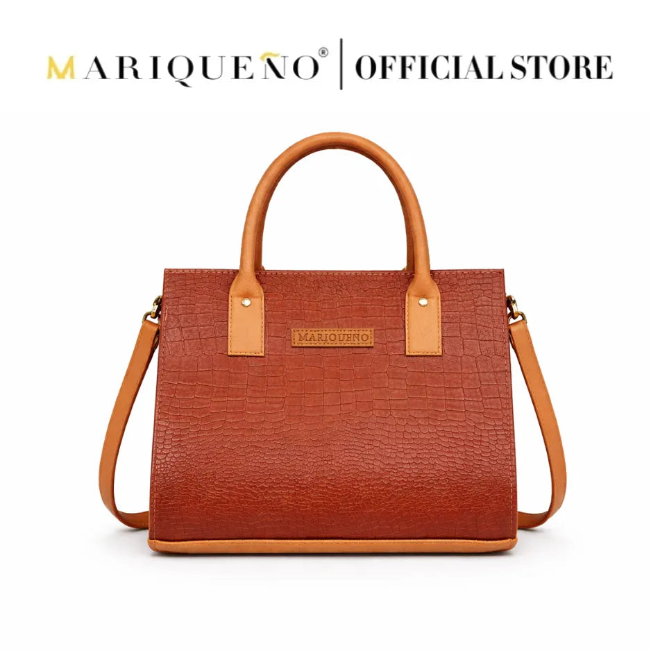 Choco brown handbag with tan handle and strap on a white background, featuring the Mariqueño brand.
#color_choco brown