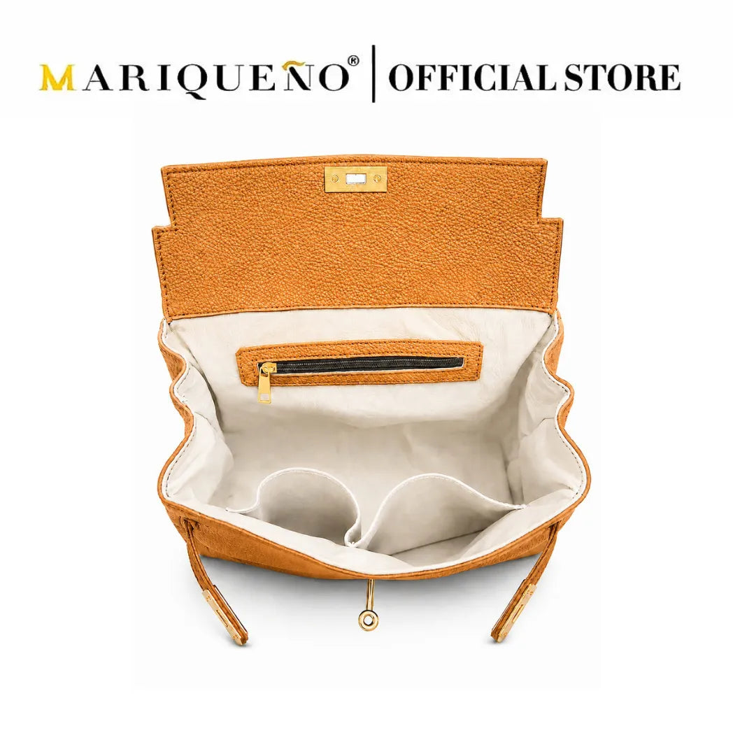 An open tan leather handbag shown from the inside, revealing a cream-colored interior lining with a zippered pocket and storage compartments. The brand name 'MARIQUEÑO | OFFICIAL STORE' is displayed at the top of the image.
#color_tan