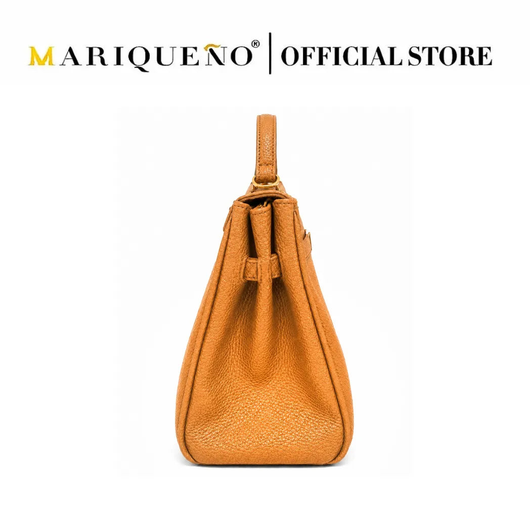 A tan pebbled leather shoulder bag with a top handle, shown from the back against a white background, with 'MARIQUEÑO | OFFICIAL STORE' text at the top.
#color_tan