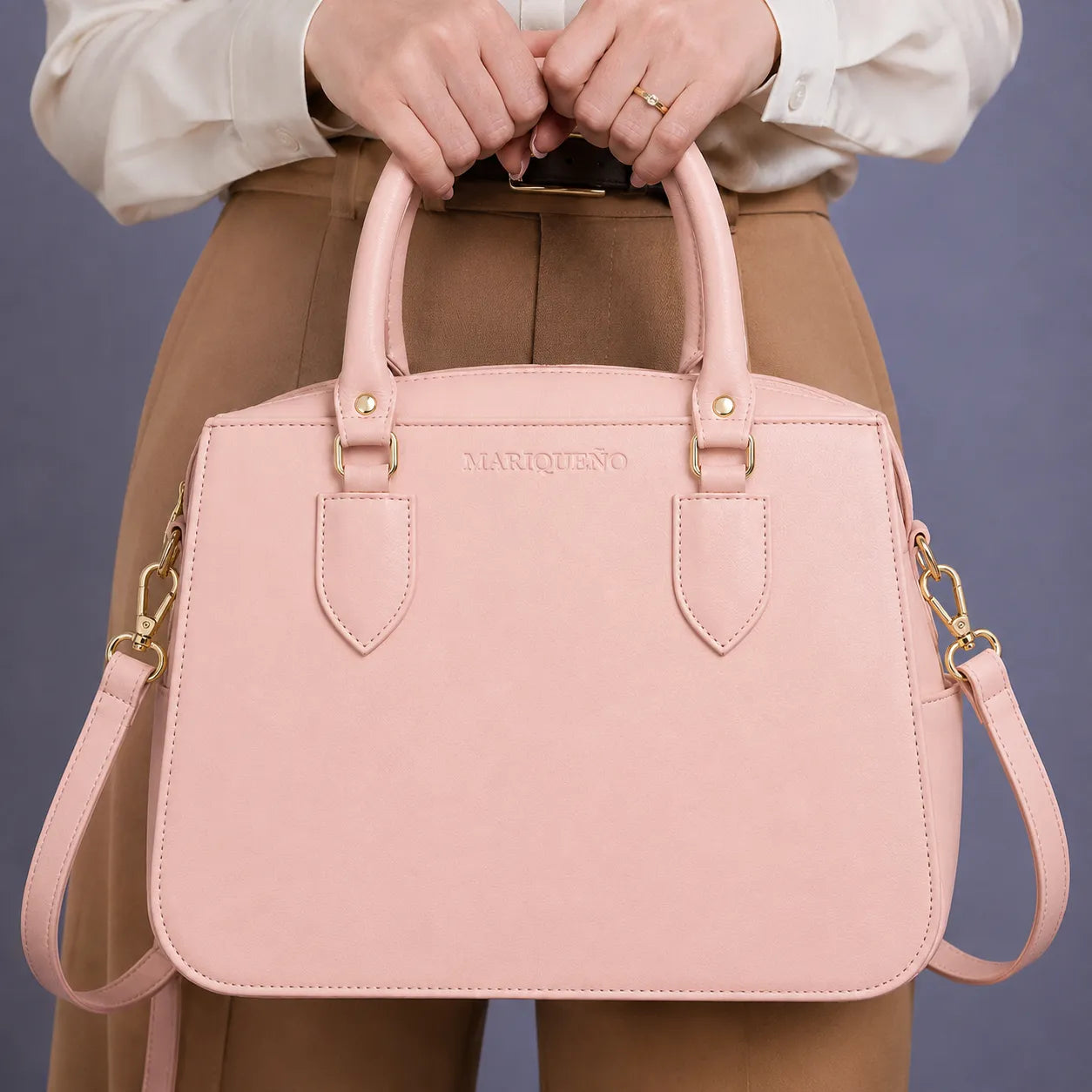 Person holding a pink handbag against a beige background
#color_salmon pink