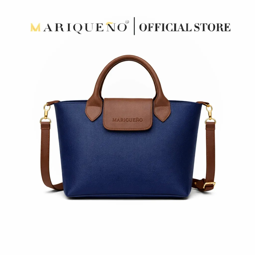 Blue handbag with brown handle and accents, featuring Mariqueno branding on a white background.
#color_blue