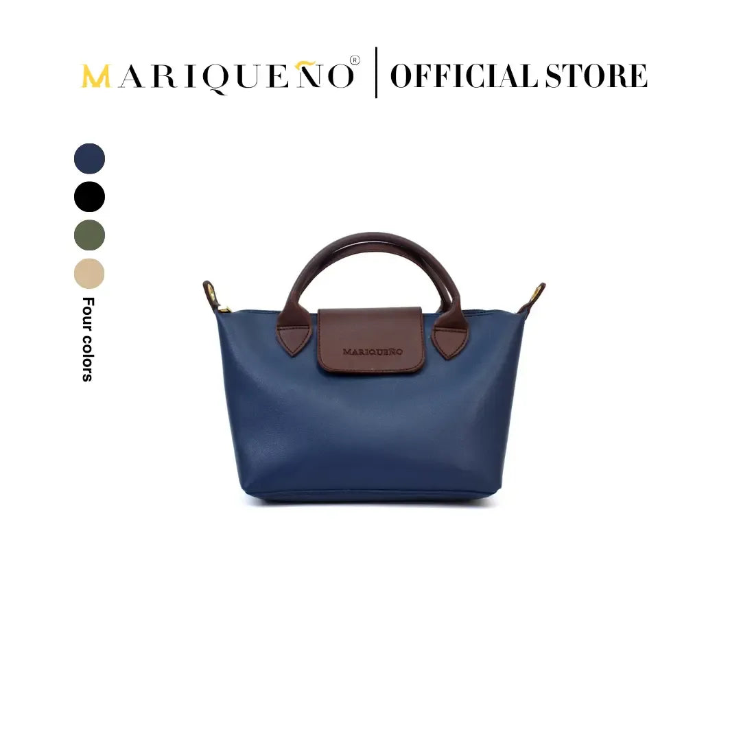 Blue handbag with brown handle and accents, featuring Mariqueno branding on a white background.
#color_blue