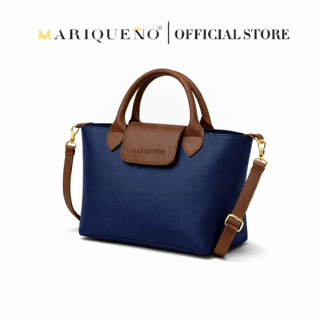 Blue handbag with brown accents and strap, featuring Mariqueno branding on a white background.
#color_blue