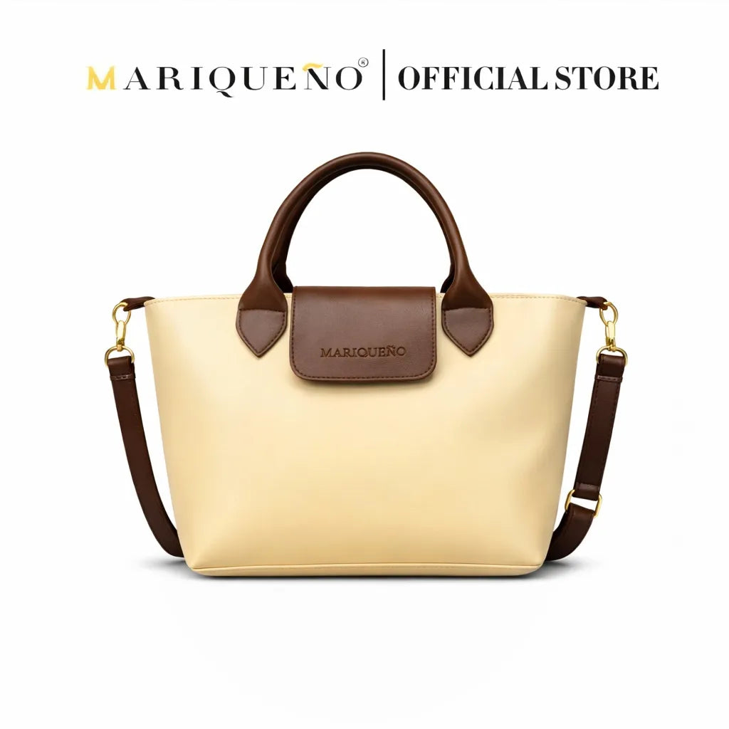 Beige handbag with brown handle and accents, featuring Mariqueño branding on a white background.
#color_cream