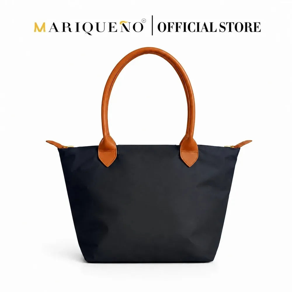 Black tote bag with brown handles and accents on a white background, featuring the Marqueno logo.
#color_black and tan