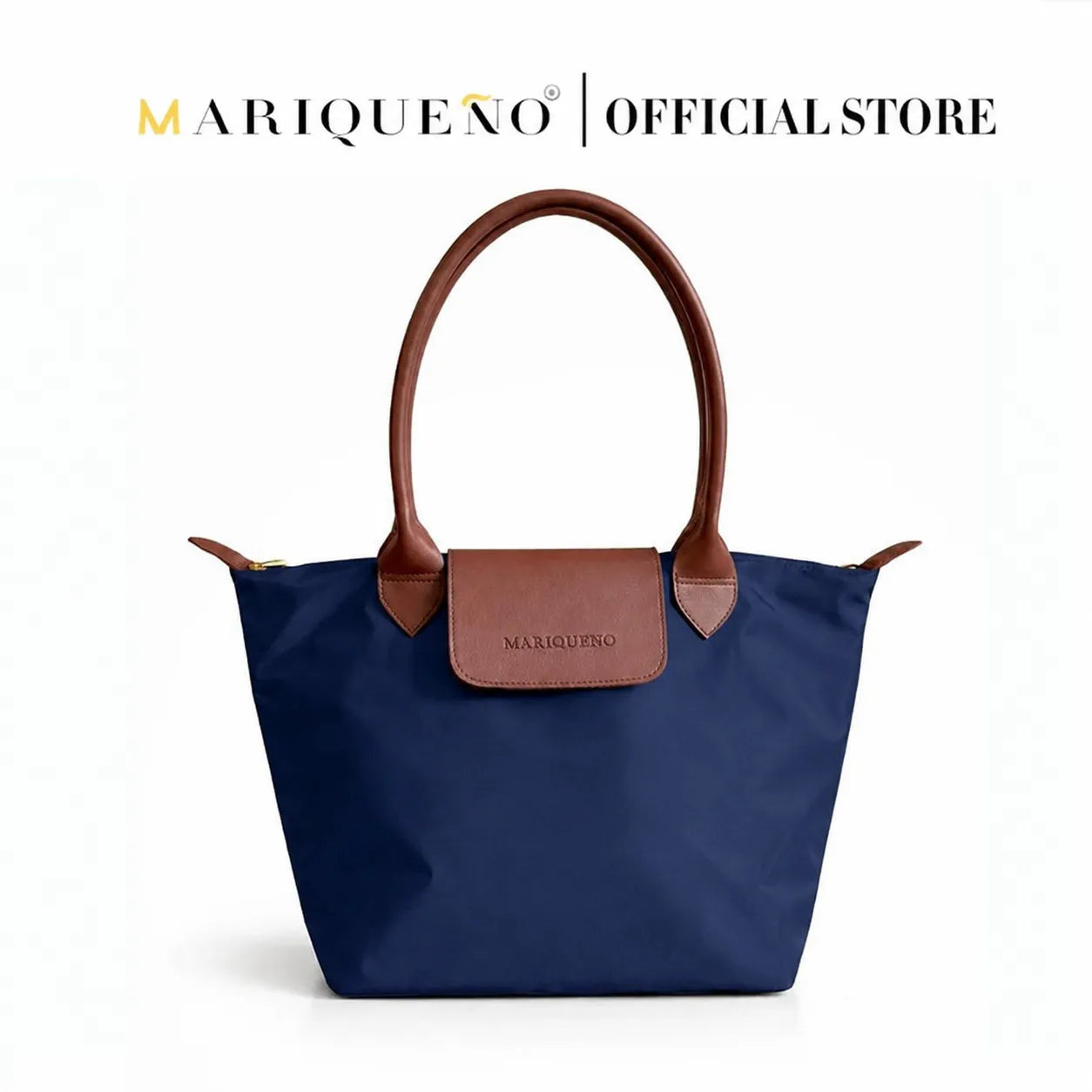 Blue handbag with brown handles and a patch on a white background, featuring the Marqueeno brand.
#color_navy blue