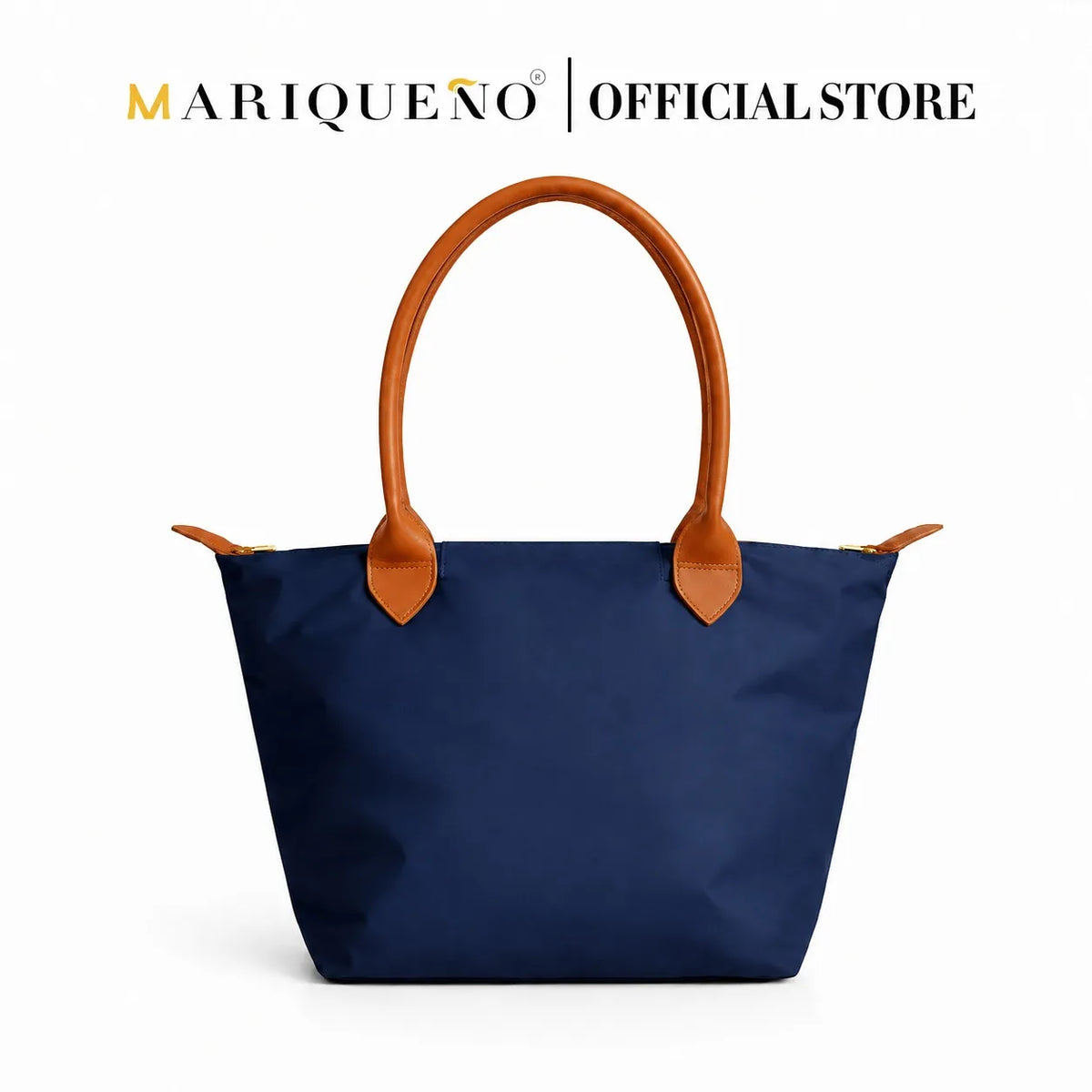 A navy blue fabric tote bag with tan leather handles and zipper pulls, shown against a plain white background with 'MARIQUENO | OFFICIALSTORE' text at the top.
#color_navy blue and tan