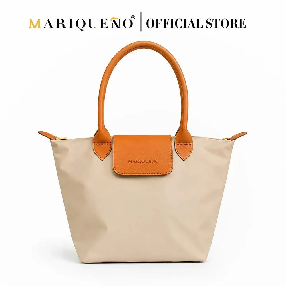 Taupe handbag with brown handles and accents on a white background, featuring the Mariqueno brand.
#color_taupe
