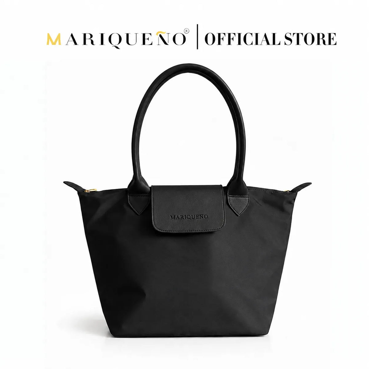 A black tote bag by Mariqueno, featuring a top handle, a front flap with debossed branding, and gold-tone zipper pulls, set against a plain white background with 'MARIQUENO | OFFICIAL STORE' text at the top.
#color_triple black