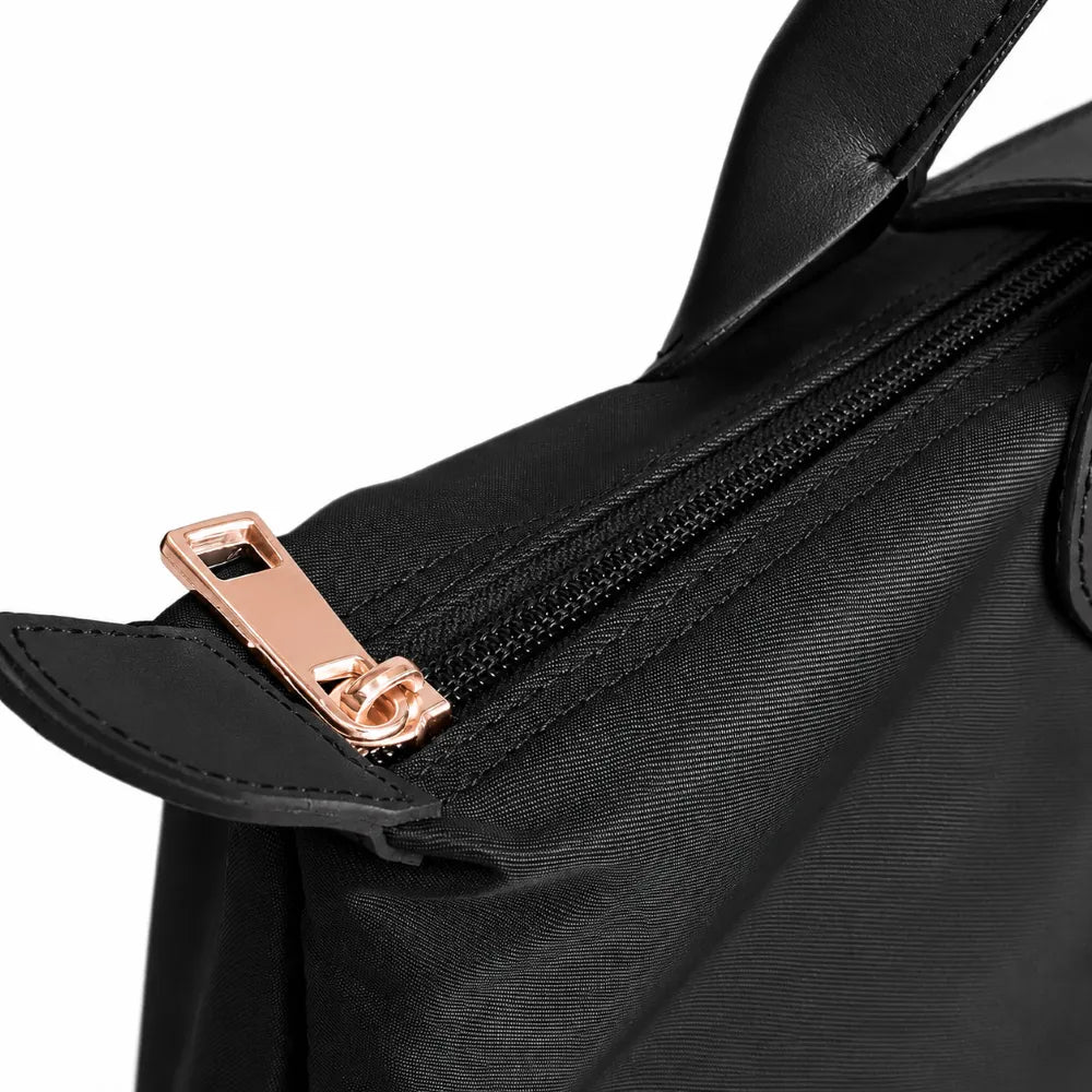 Close-up of a black nylon handbag showing the zipper.
#color_triple black