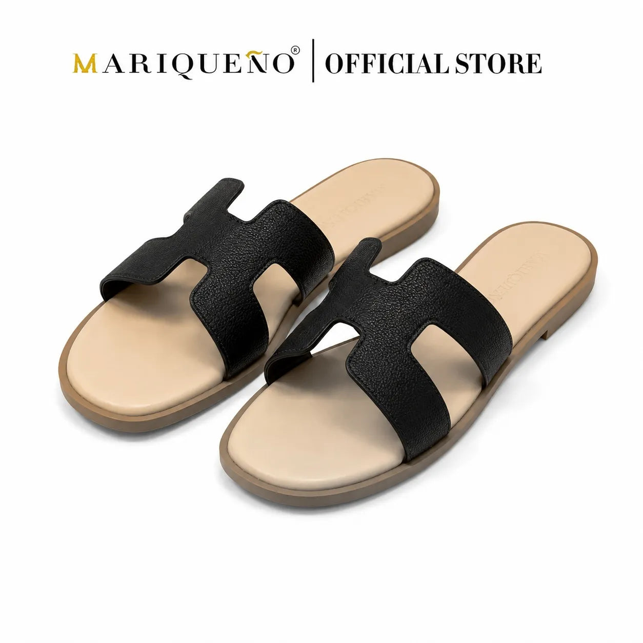 A pair of black H-shaped slide sandals with beige insoles and soles, displayed on a clean white background with 'MARIQUENO | OFFICIAL STORE' text at the top.
#color_black