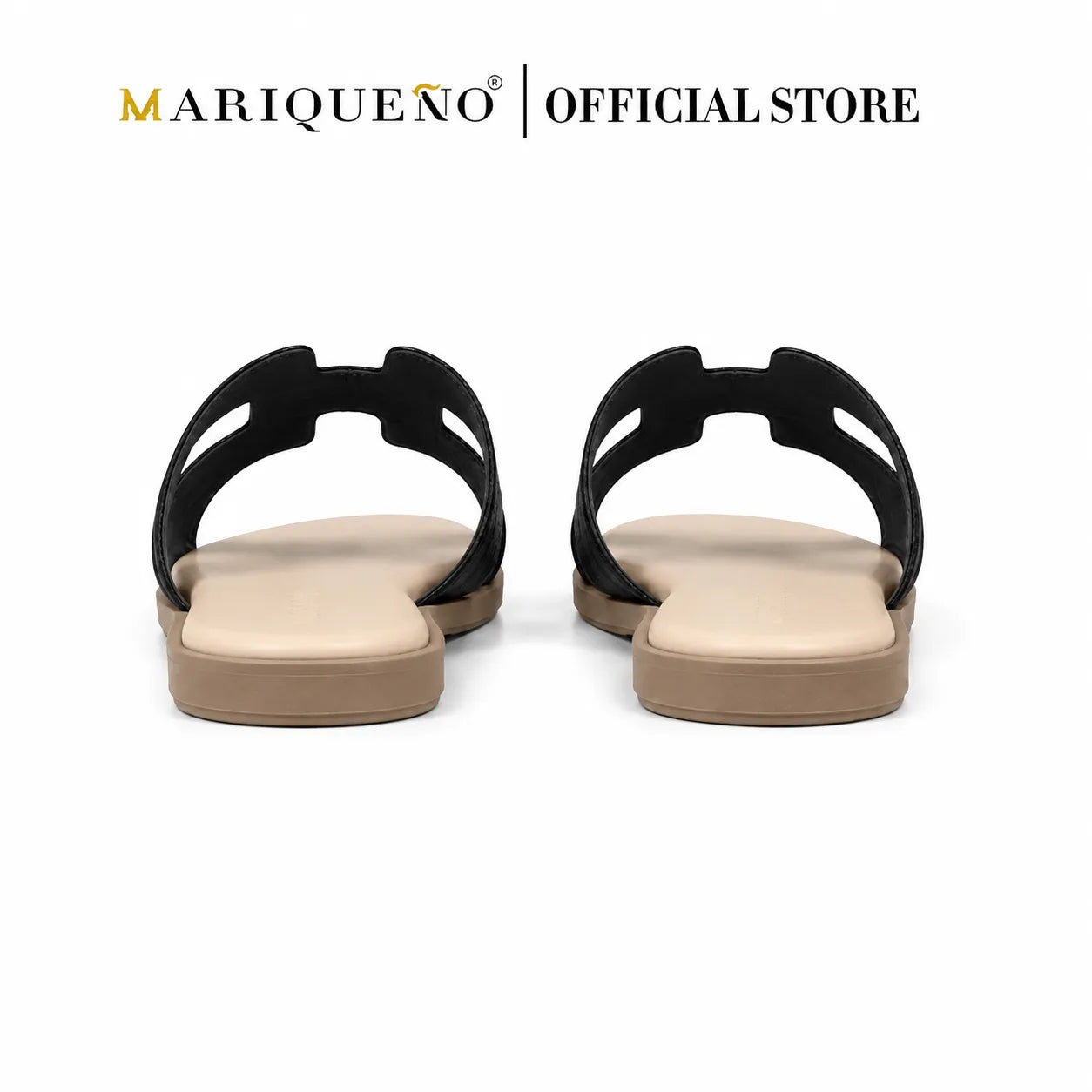 A pair of black slide sandals with beige footbeds and tan soles, shown from the back on a white background with 'MARIQUEÑO | OFFICIAL STORE' text at the top.
#color_black