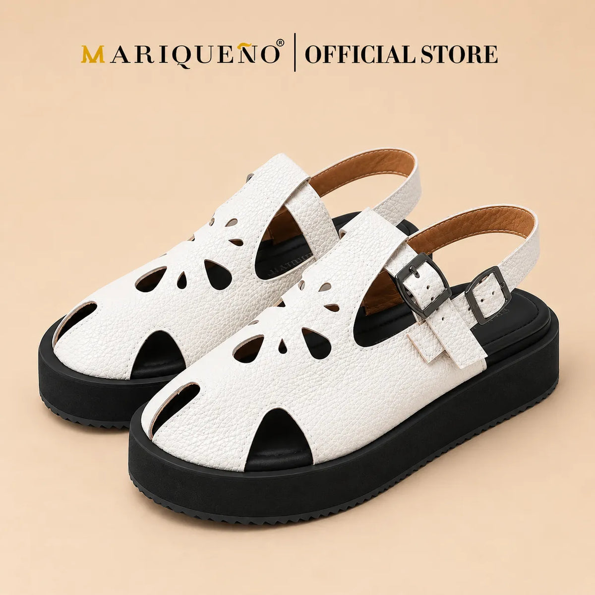 A pair of white textured leather slingback sandals with black soles and cutout details on the toe and sides, shown against a plain white background with 'MARIQUENO | OFFICIAL STORE' text at the top.
#color_white