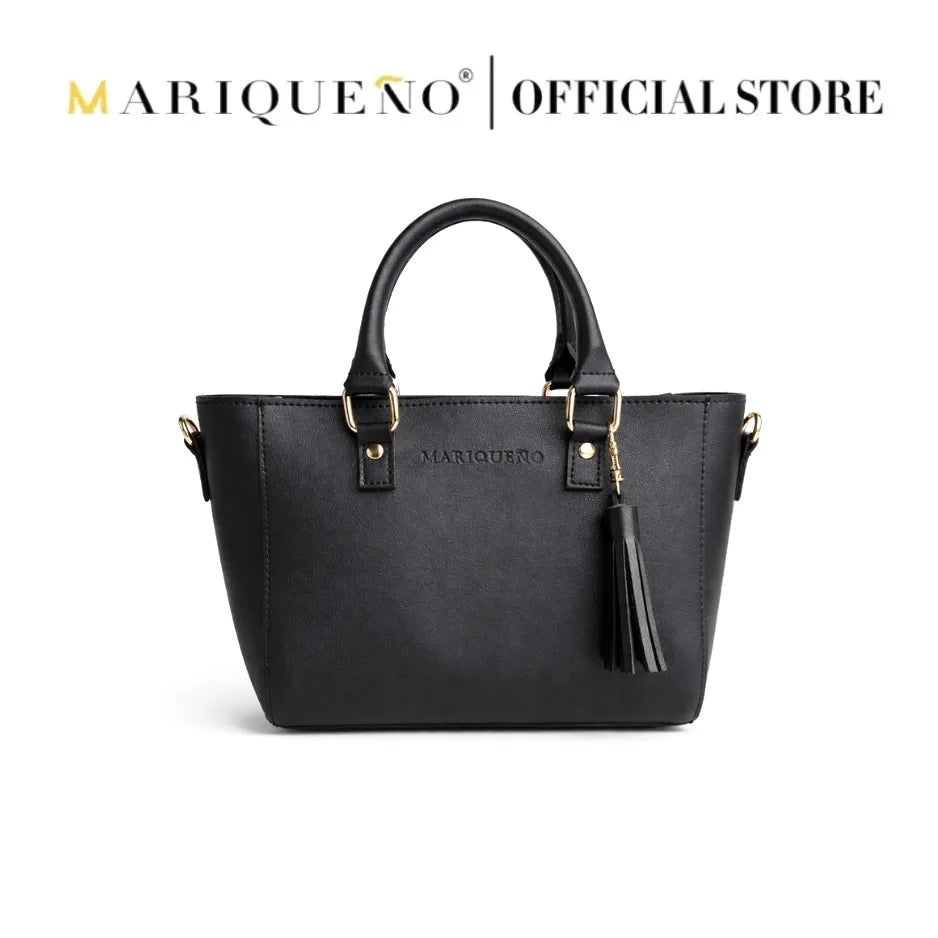 Black handbag with gold accents and a tassel on a white background, featuring the Mariqueño brand.
#color_black