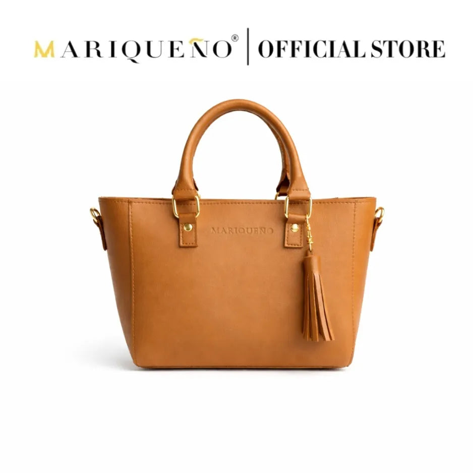 Tan brown handbag with tassel and 'Mariqueno' branding on a white background
#color_tan brown