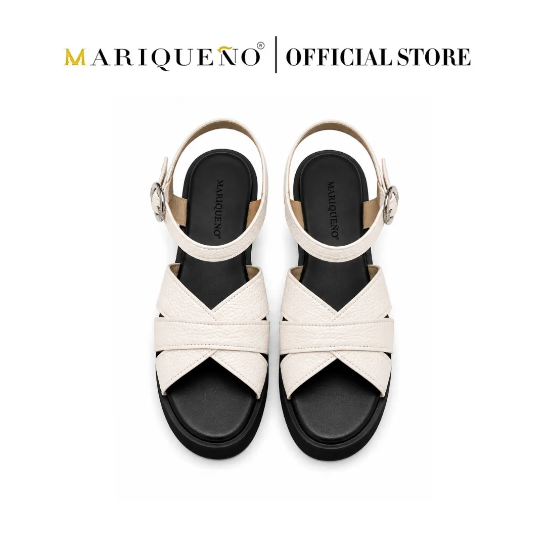 A pair of Mariqueno brand women's flat sandals with cream-colored textured straps, a black sole, and silver buckle details, shown against a plain white background with the 'Mariqueno | Official Store' logo at the top.
#color_white
