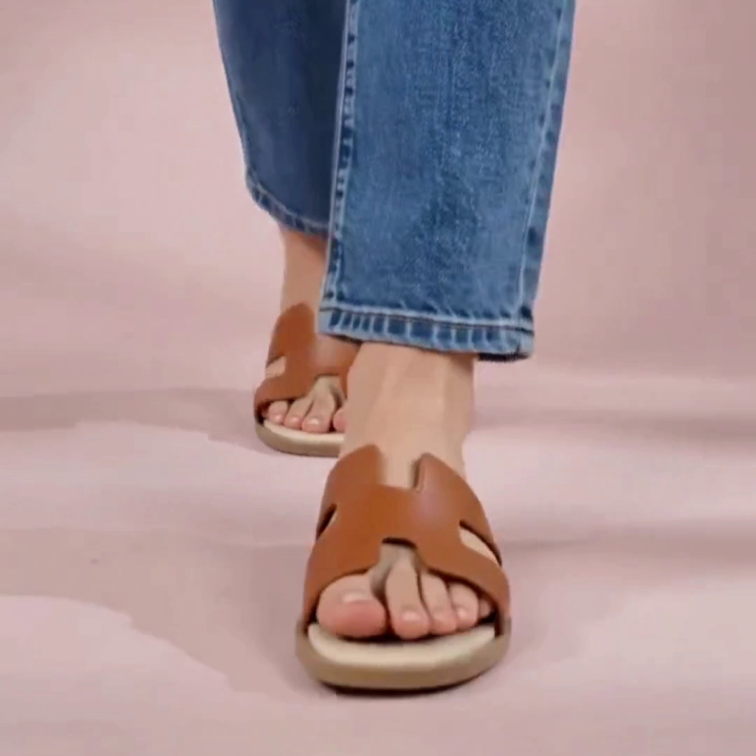 A woman wearing tan h-shaped flats
#color_tan