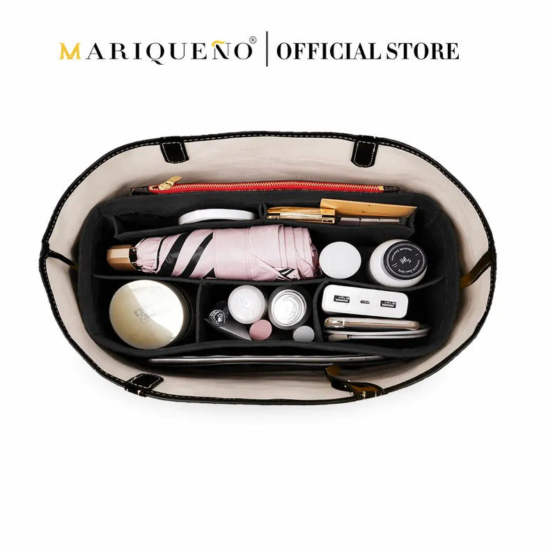 Open handbag with various items and Marqueéno logo at the top.
#color_black