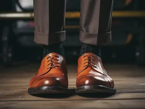 Image of a person wearing a pair of shiny brown leather shoes