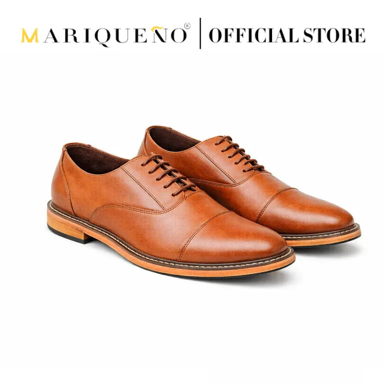 Pair of tan brown leather shoes with 'Mariqueno' branding on a white background
#color_tan