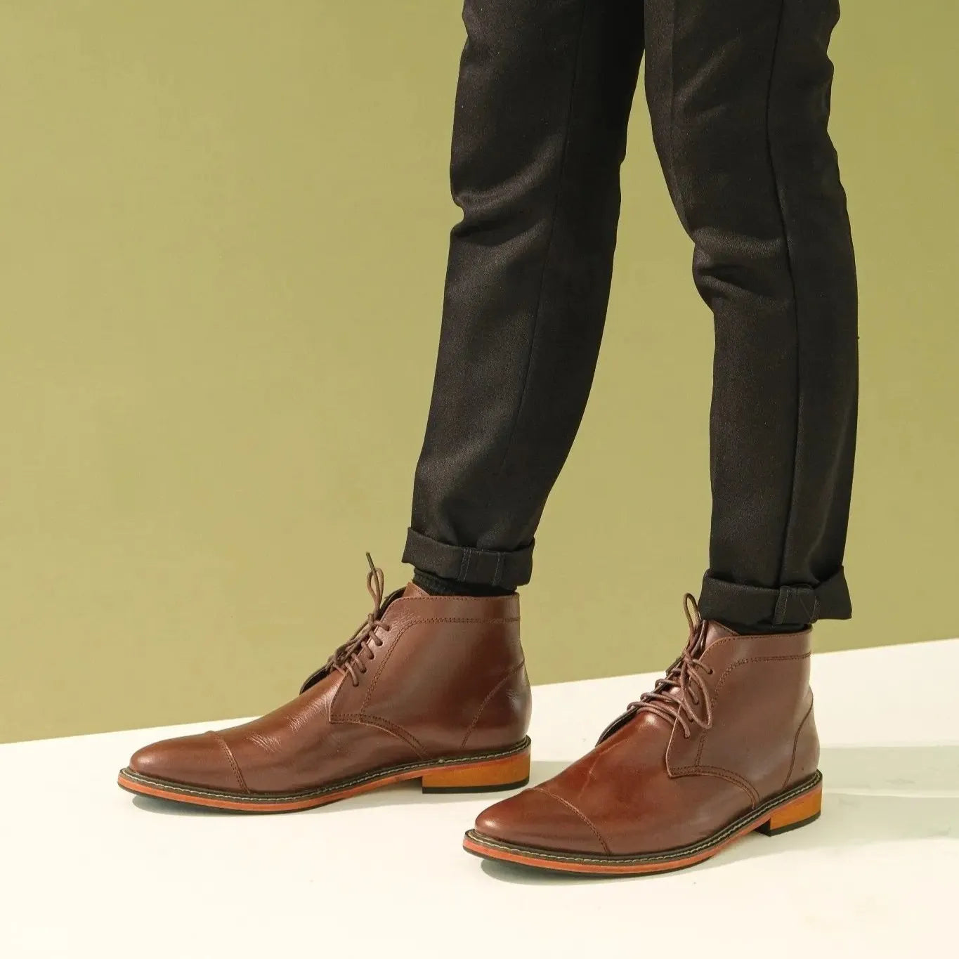 A pair of walnut brown Chukka Boots worn by model
#color_walnut