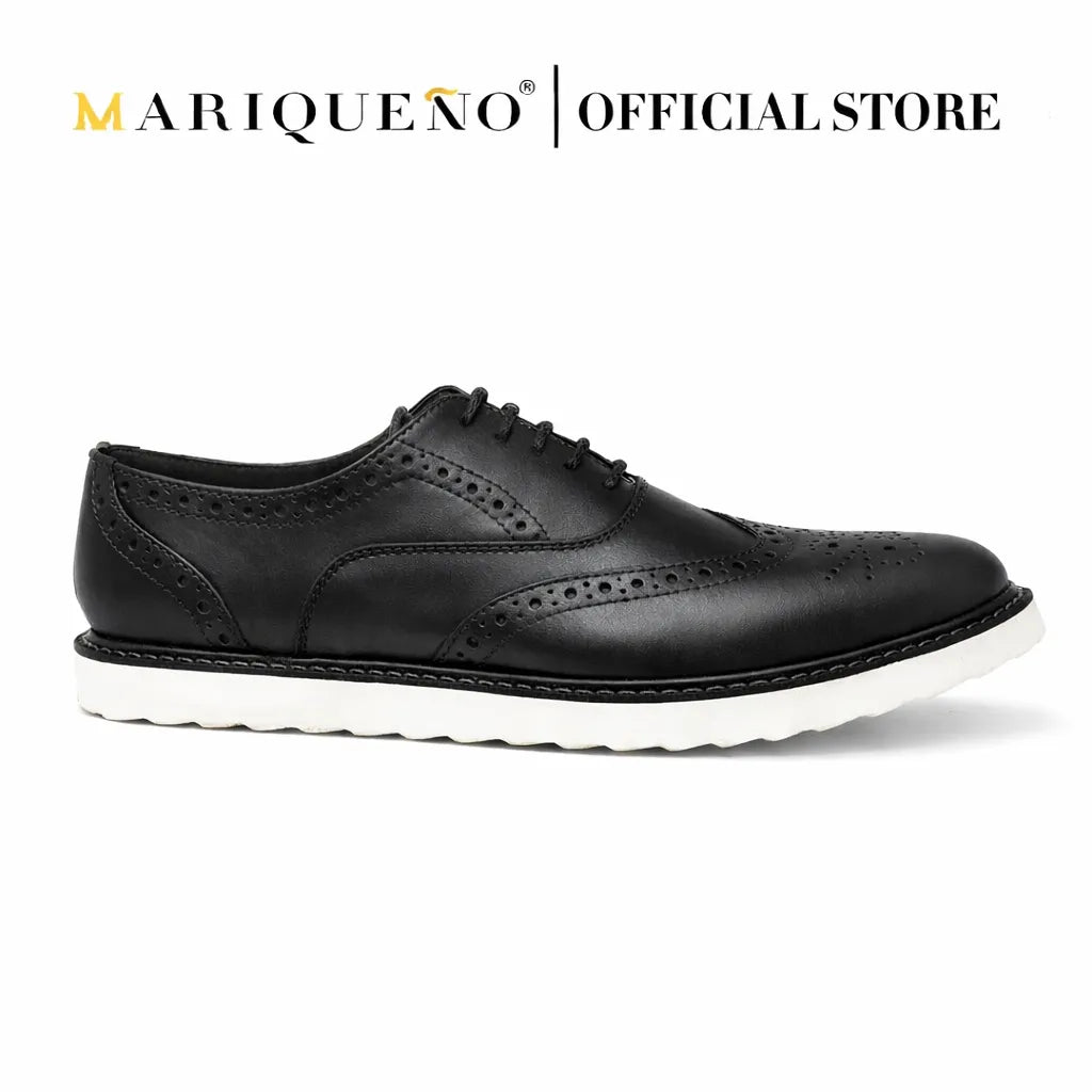 Black leather wingtip shoe with white rubber sole on a white background, featuring the Mariqueno brand.
#color_black