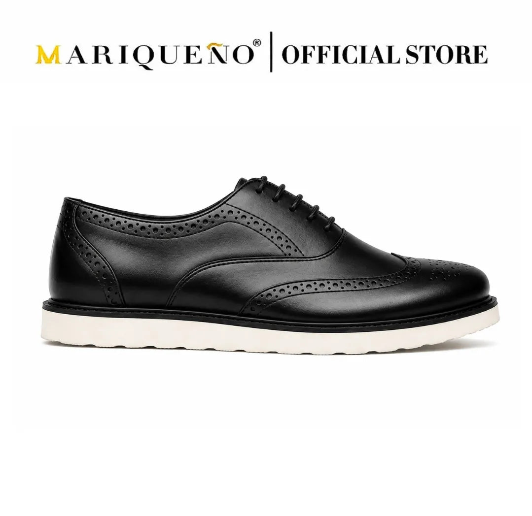 Black leather wingtip shoe with white rubber sole on a white background, featuring the Mariqueno brand.
#color_black