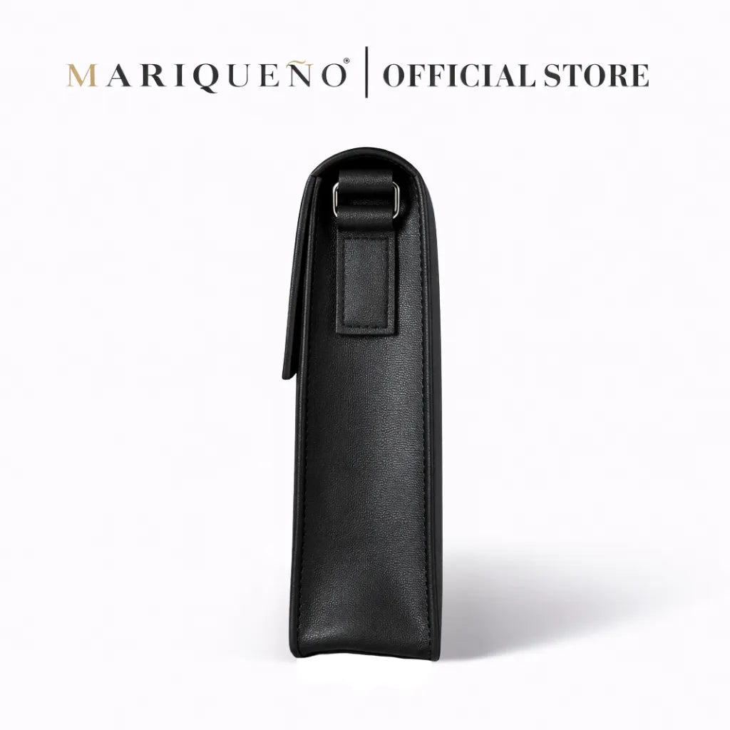 Black leather top handle bag with strap on a white background, branded as Mariqueno.
#color_black