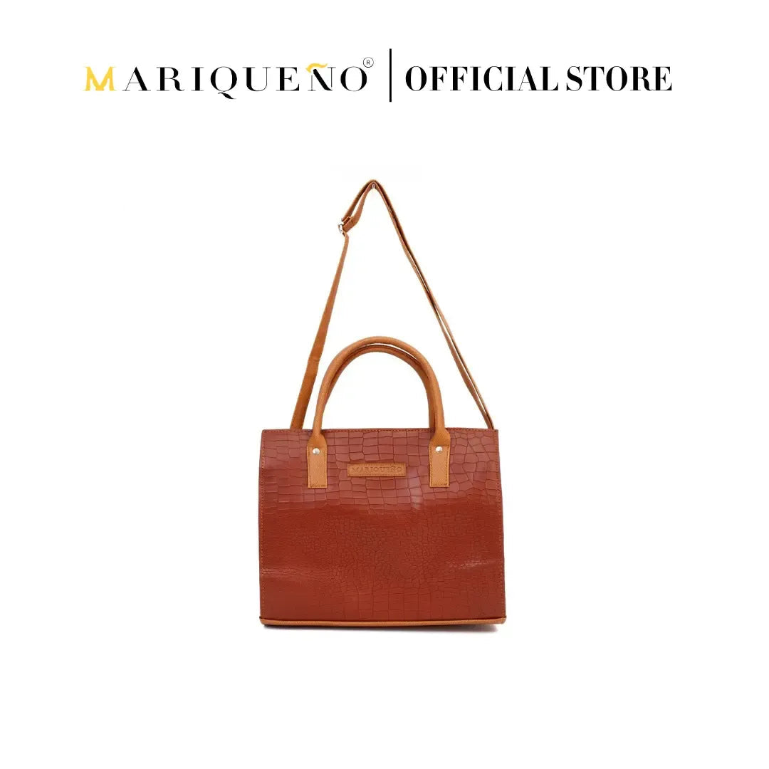 Brown handbag with shoulder strap on a white background, featuring the Mariqueño brand.

#color_choco brown