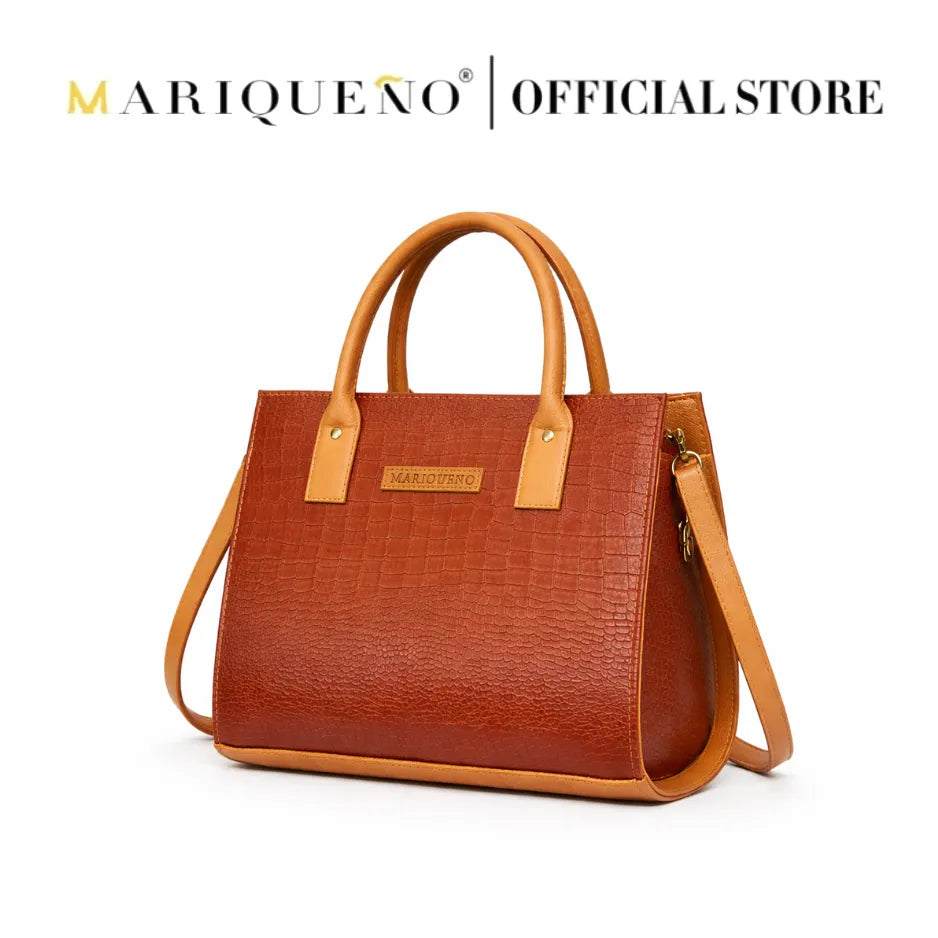 Choco brown handbag with tan straps on a white background, featuring the Mariqueño brand.
#color_choco brown
