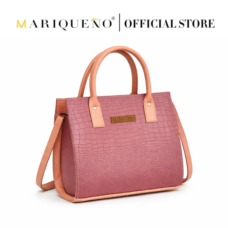 Pink handbag with brown handles and strap on a white background, featuring the Mariqueno logo.
#color_old rose