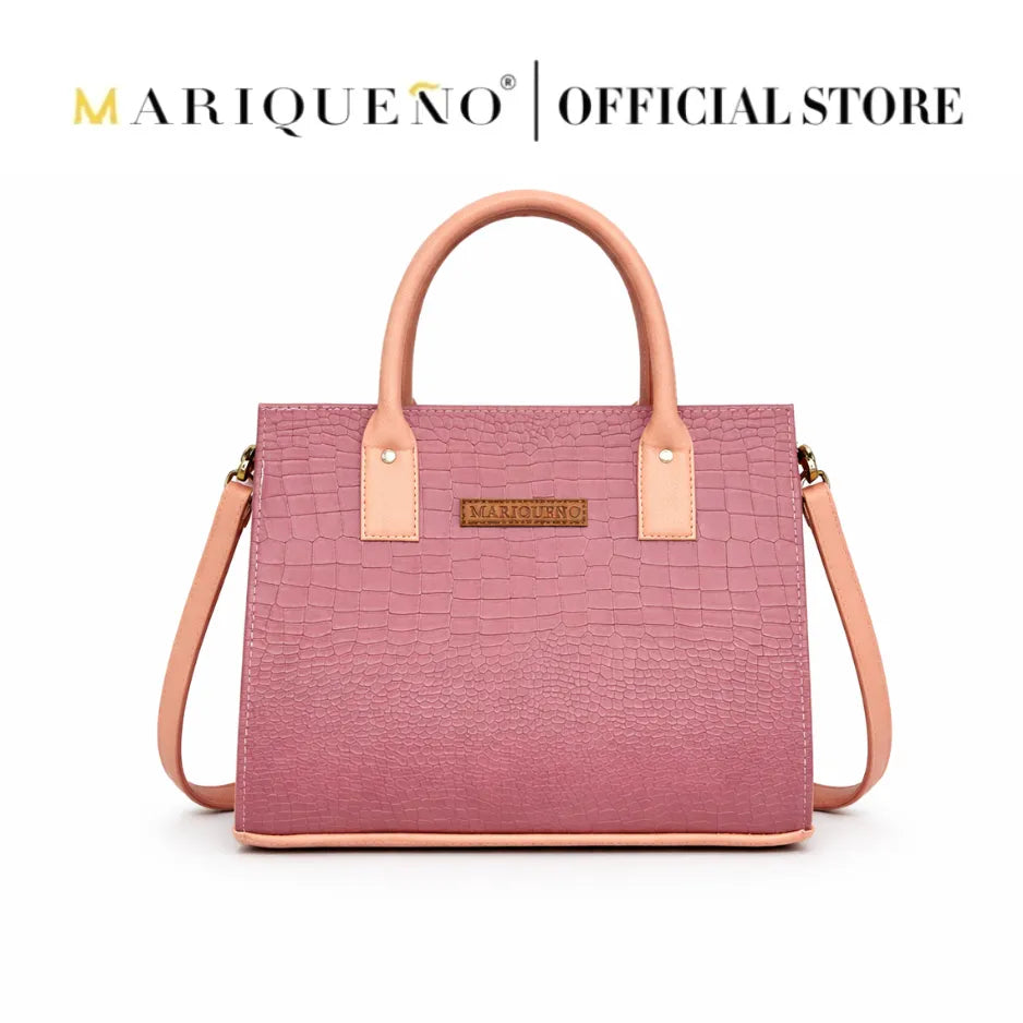 Pink handbag with tan handles and strap on a white background, featuring the Mariqueno logo.
#color_old rose