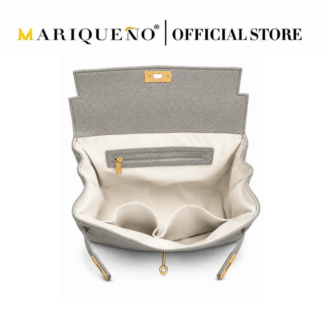An open gray textured handbag with a cream-colored interior, gold zipper details, and a small gold logo plaque, shown on a white background with 'MARIQUEÑO | OFFICIAL STORE' text at the top.
#color_gray