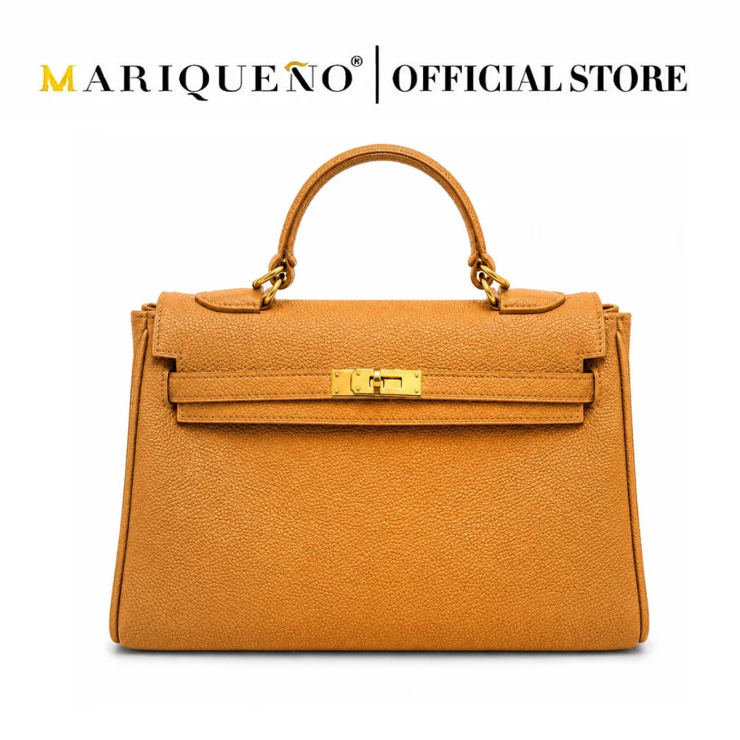 A structured tan leather handbag with a top handle, gold-tone hardware, and a front strap closure, shown on a plain white background with the text 'MARIQUEÑO | OFFICIAL STORE' at the top.
#color_tan
