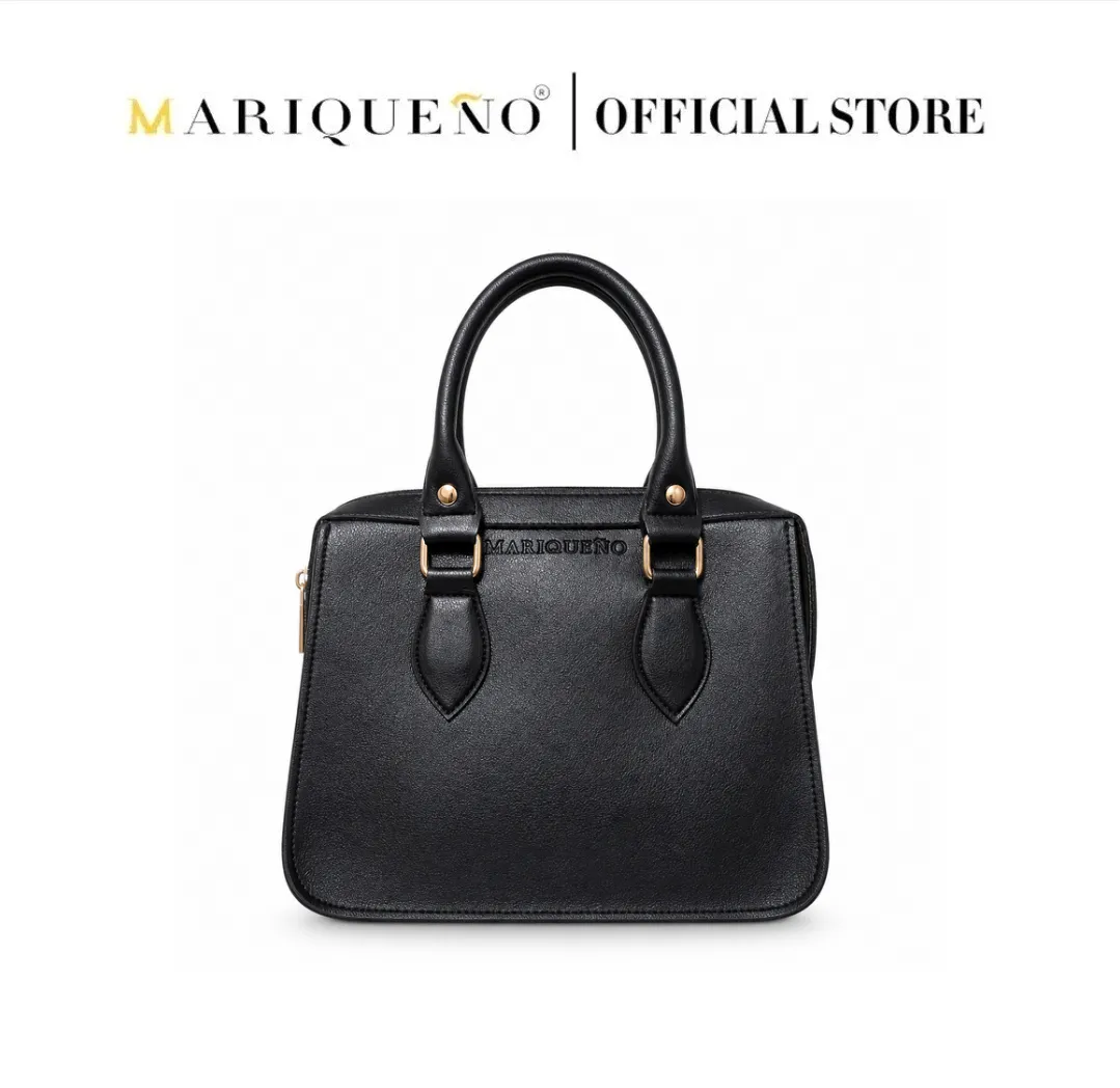 Black handbag with gold accents on a white background, featuring the Mariqueño brand.
#color_black