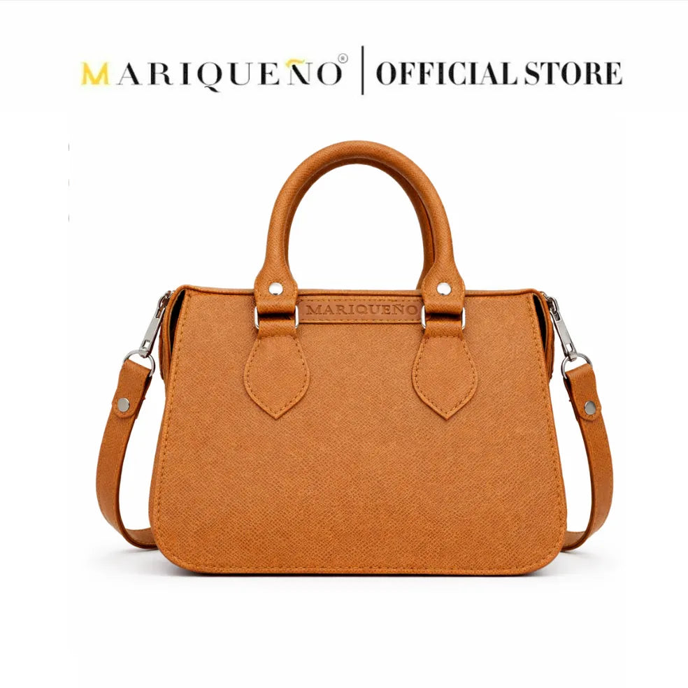 Brown handbag with a strap on a white background, featuring the Marqueéno brand.
#color_tan brown