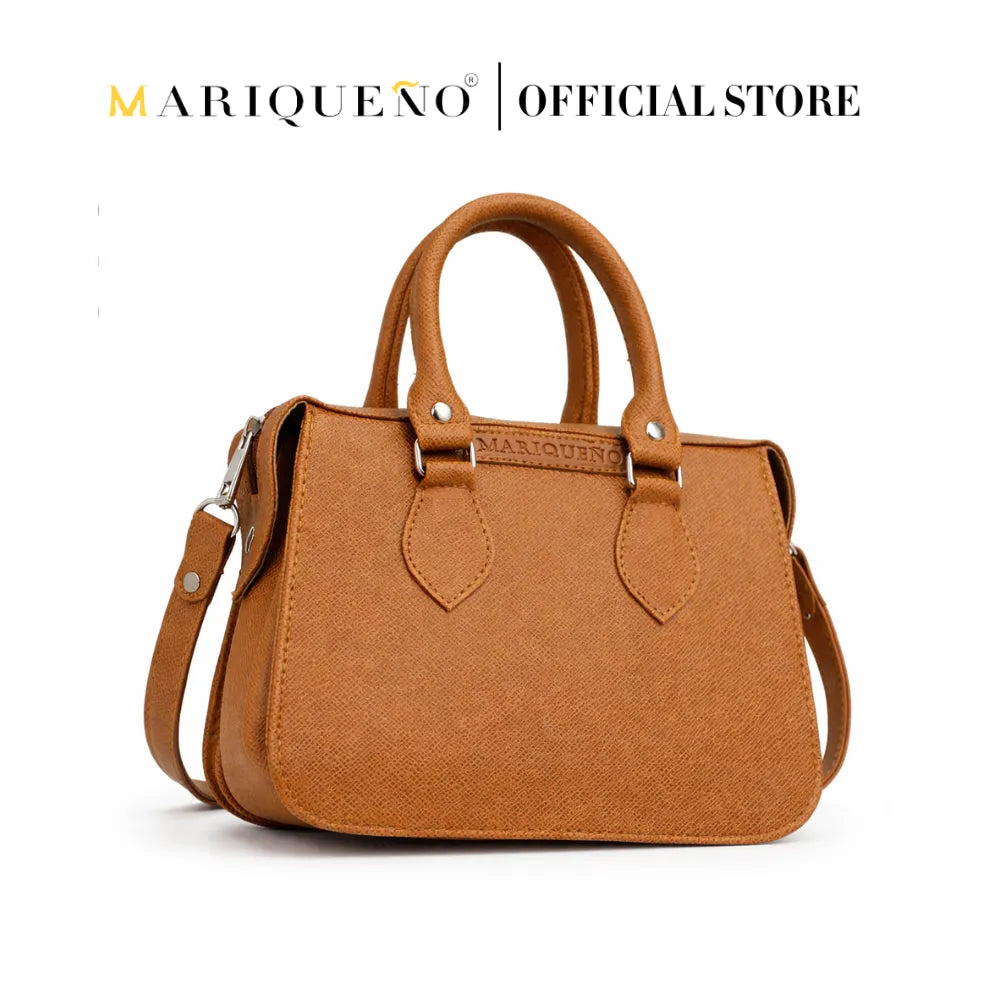 Brown leather handbag with shoulder strap on a white background, featuring the Marqueéno brand.
#color_tan brown