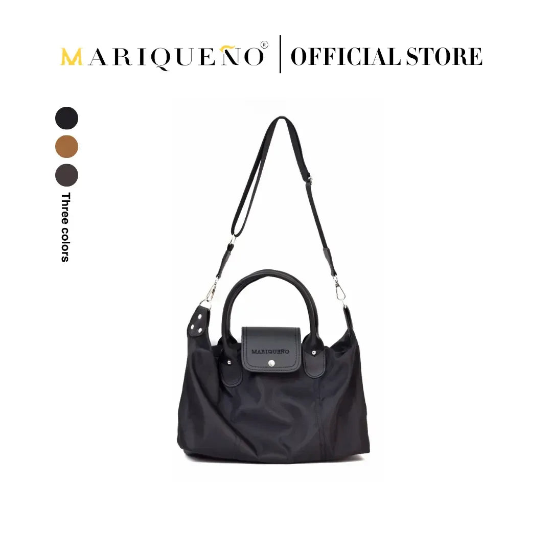 Black handbag with shoulder strap on a white background, featuring the Mariqueño brand.
#color_black