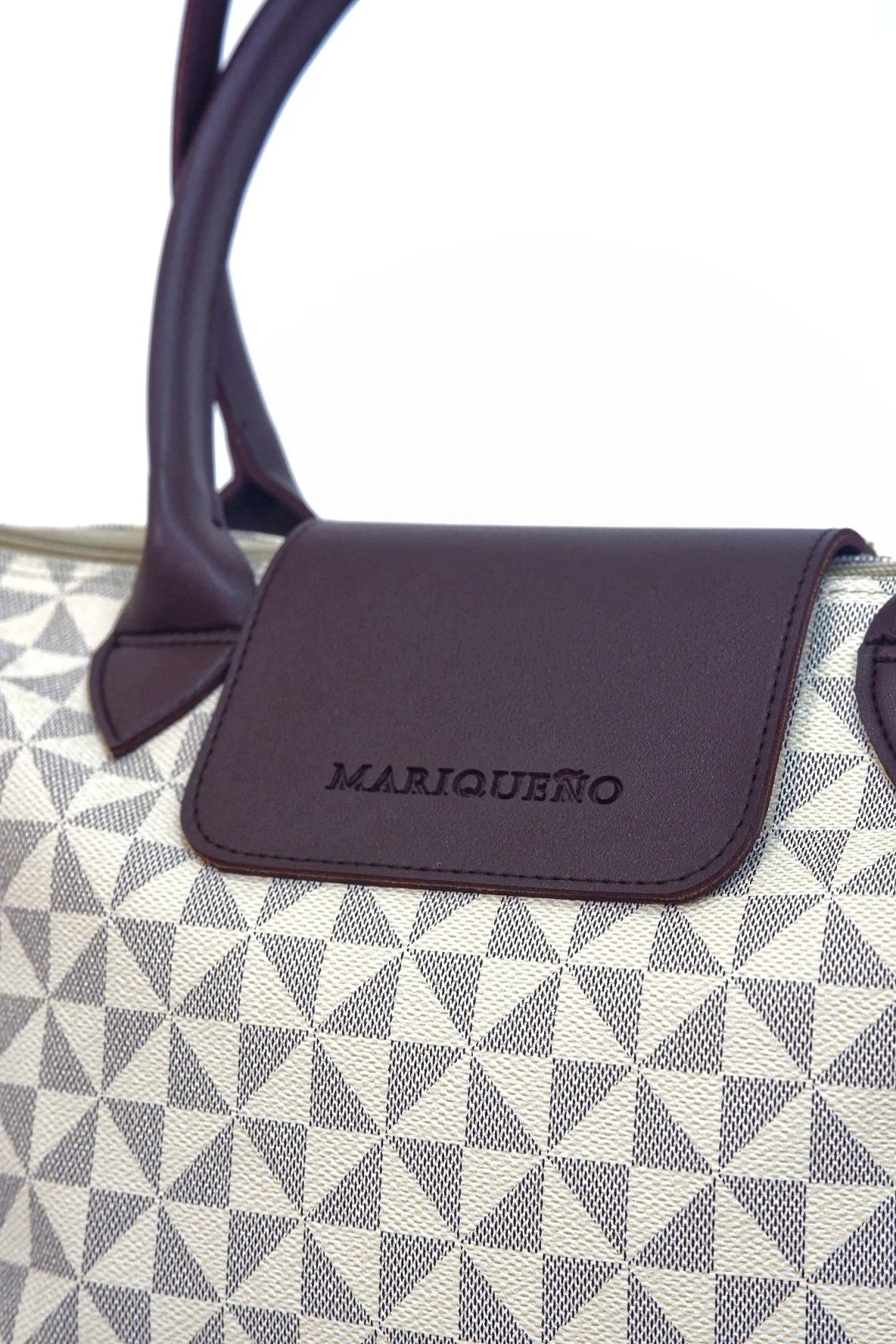 Handbag with geometric pattern and visible brand name on a white background
#color_sandstone geo