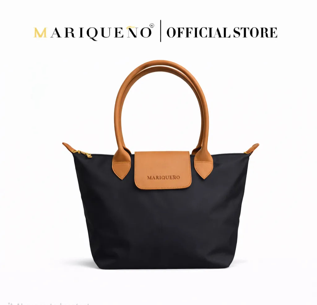 Black handbag with brown handles and accents on a white background, featuring the Mariqueno brand.
#color_black