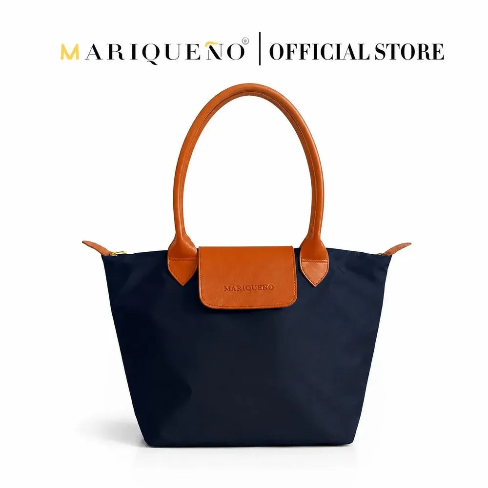 Black handbag with brown handles and accents on a white background, featuring the Mariqueno brand.
#color_black and tan